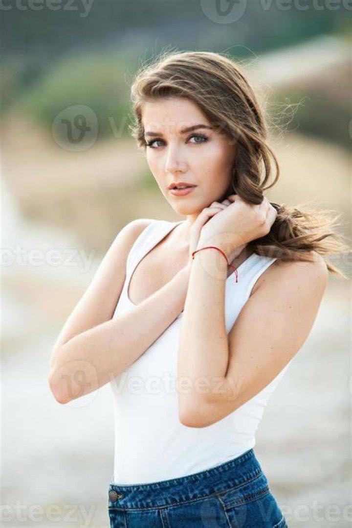 kaia gerber elle cover shoot february 2023 a white brunette woman stands on a beach shoreline wearing an american flag gown