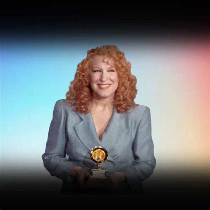 Bette Midler holding a piece of paper during an interview with host Johnny Carson