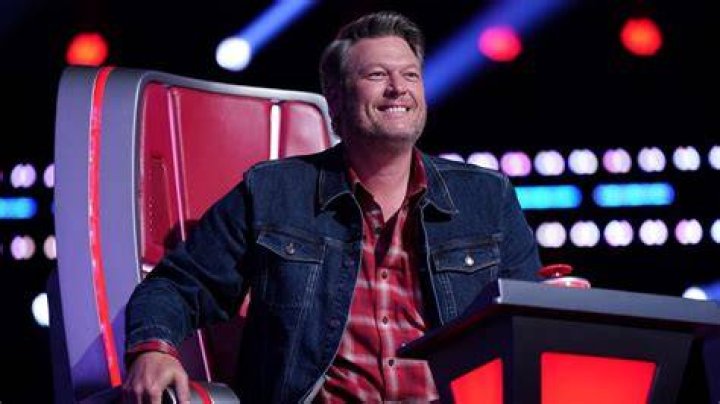 Bodie performs on The Voice Season 22 finale under dark blue lighting