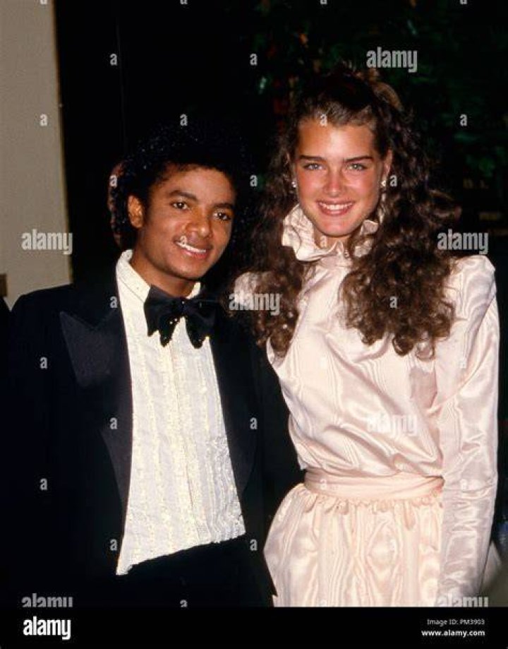Brooke Shields and Michael Jackson near a lamp