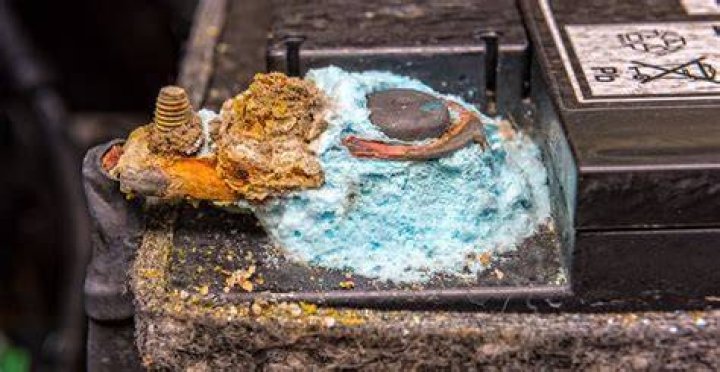 How does Coke remove battery corrosion?