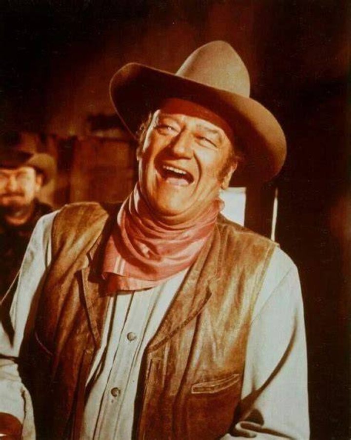 John Wayne in costume, laughing, while filming 'The Undefeated'