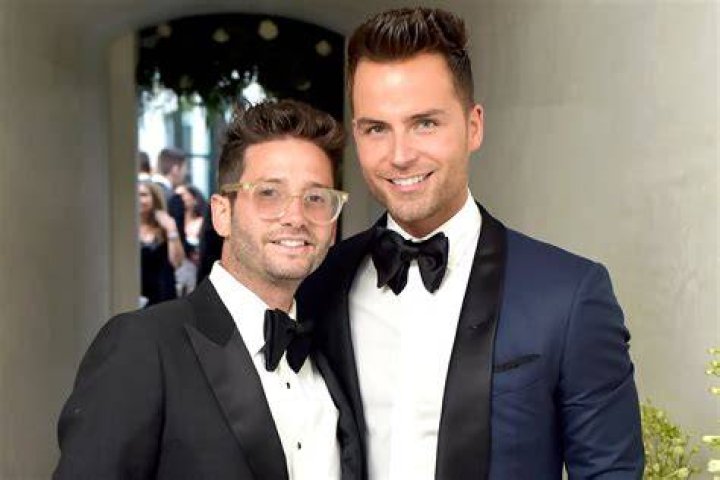 Josh Flagg and Bobby Boyd hold hands on their way into a listing on 'Million Dollar Listing'
