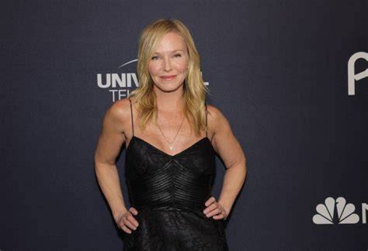 Kelli Giddish posing on the set of 'Law & Order SVU' wearing a police uniform.