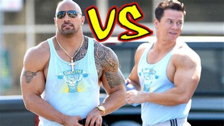 Mark Wahlberg and Dwayne Johnson on the set of 'Pain and Gain' shaking hands.