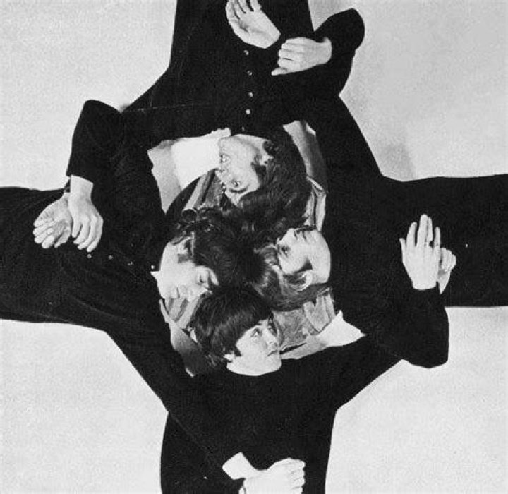The Beatles pose with bottles of beer, party snacks, and balloons in October 1964. Left to right: Paul McCartney, John Lennon (1940-1980), Ringo Starr, and George Harrison (1943-2001). The session was taken to promote the BBC World Service.